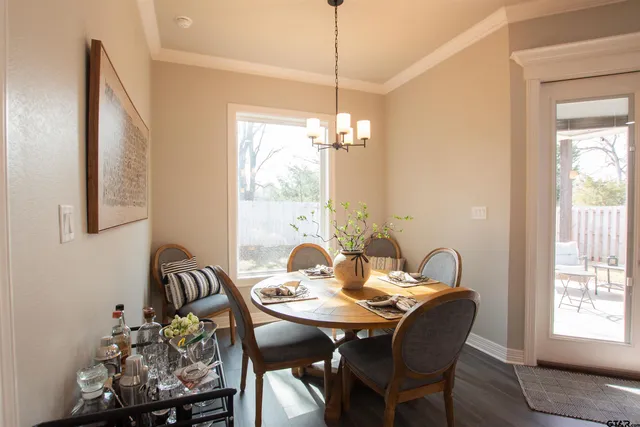 a dining room with furniture and window
