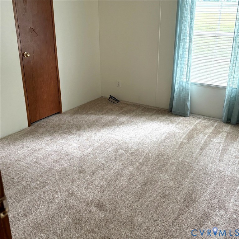 102 Frenchs Store Road Cumberland, VA 23040 - Photo 4 of 13 Neutral-toned carpeted flooring with a window feat