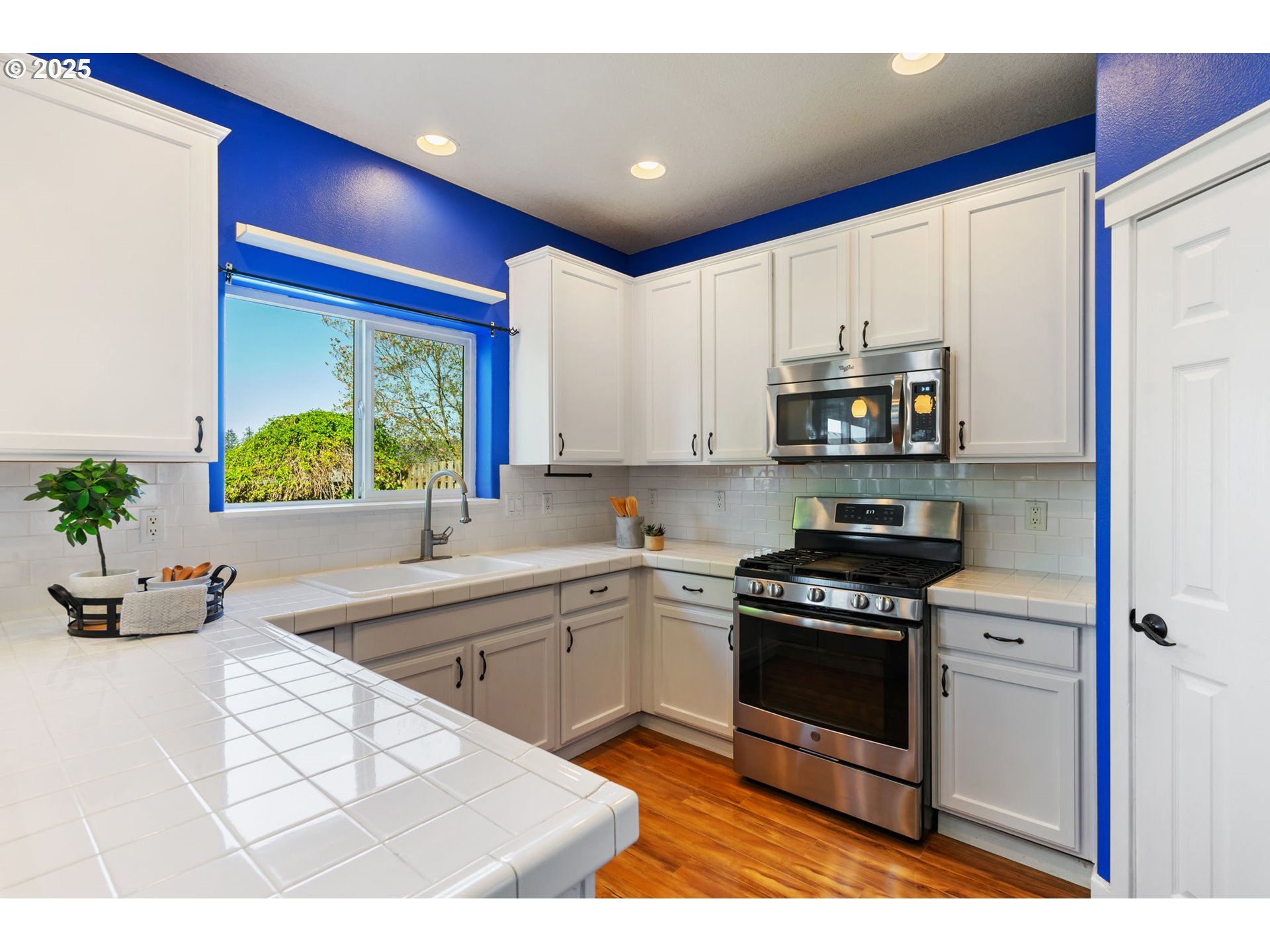 6379 Southeast 31st Terrace Gresham, OR 97080 - Photo 16 of 42 a kitchen with stainless steel appliances kitchen island granite countertop a sink and a stove