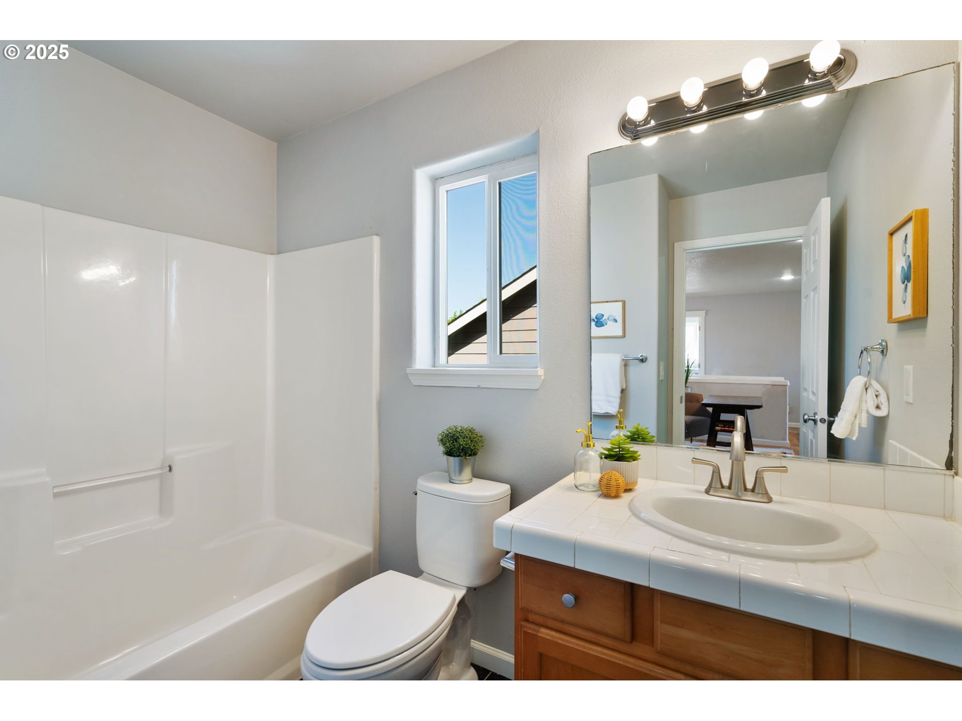 6379 Southeast 31st Terrace Gresham, OR 97080 - Photo 33 of 42 a bathroom with a sink a toilet a mirror and shower