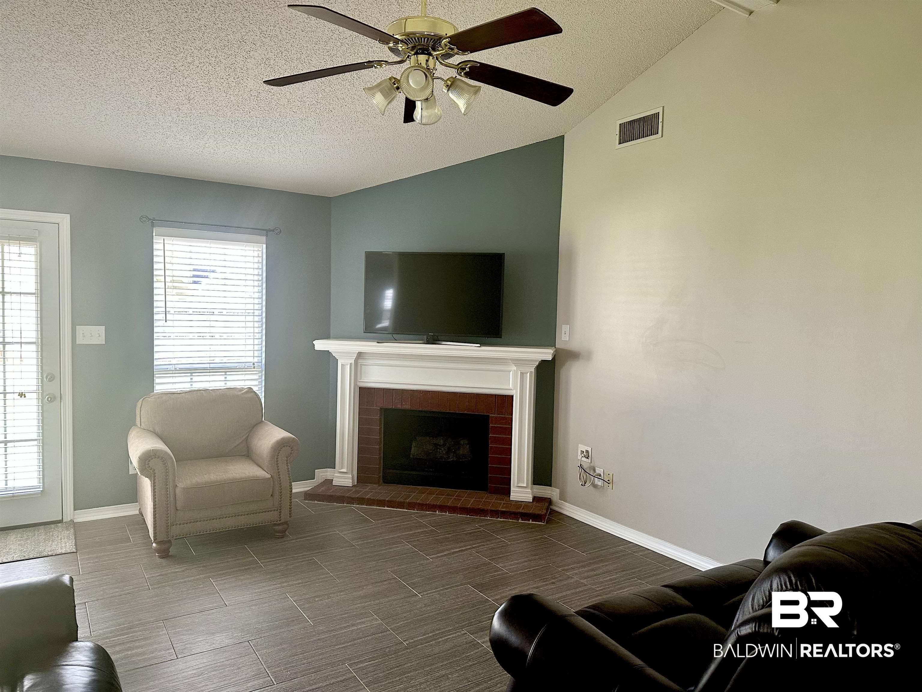 4882 Rebecca Place Mobile, AL 36695 - Photo 28 of 29 Living room with a textured ceiling, lofted ceiling, visible vents, and ceiling fan