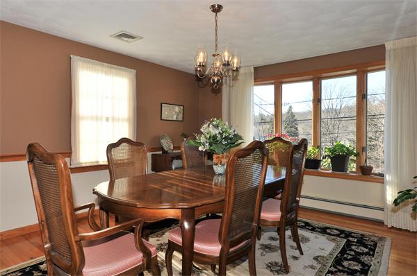 71 Stowecroft Road Arlington, MA 02474 - Photo 3 of 28 a view of a dining room with furniture a chandelier and wooden floor