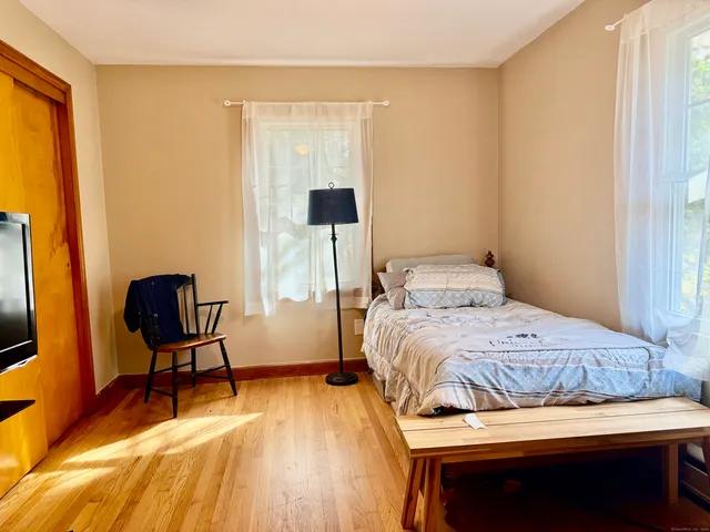 a bedroom with a bed and a chair