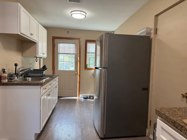 a kitchen with a sink and a refrigerator