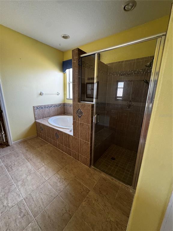 15296 Southwest 15th Terrace Road Ocala, FL 34473 - Photo 7 of 15 a bathroom with a tub and shower