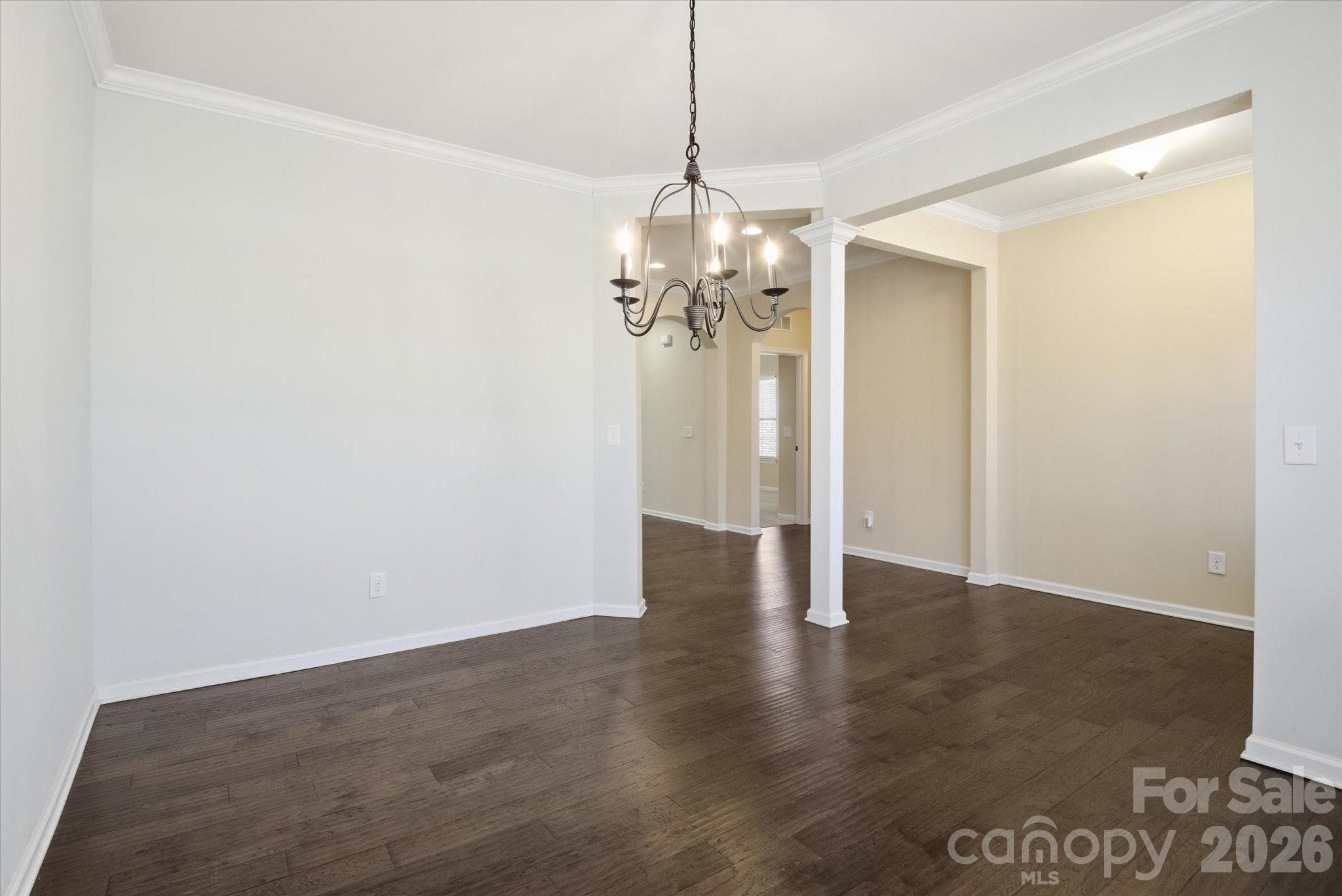 5009 St Clair Street Fort Mill, SC 29715 - Photo 14 of 40 a view of a hallway with wooden floor and a chandelier