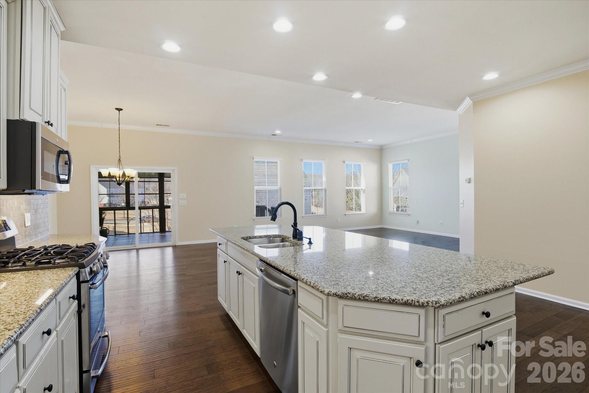 5009 St Clair Street Fort Mill, SC 29715 - Photo 17 of 40 a kitchen with granite countertop stainless steel appliances a sink a counter top space and cabinets