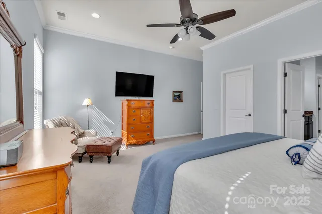 a bedroom with a bed and a tv