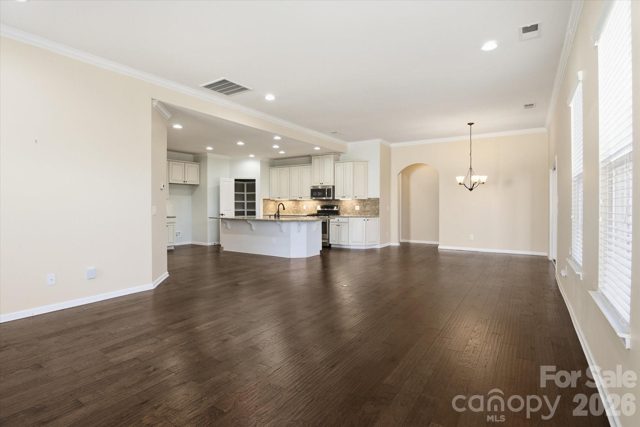 5009 St Clair Street Fort Mill, SC 29715 - Photo 21 of 40 a view of a kitchen with cabinets and wooden floor