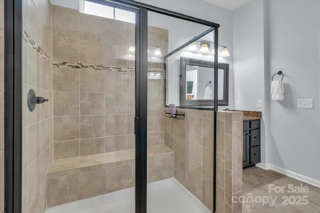 a bathroom with a glass shower door