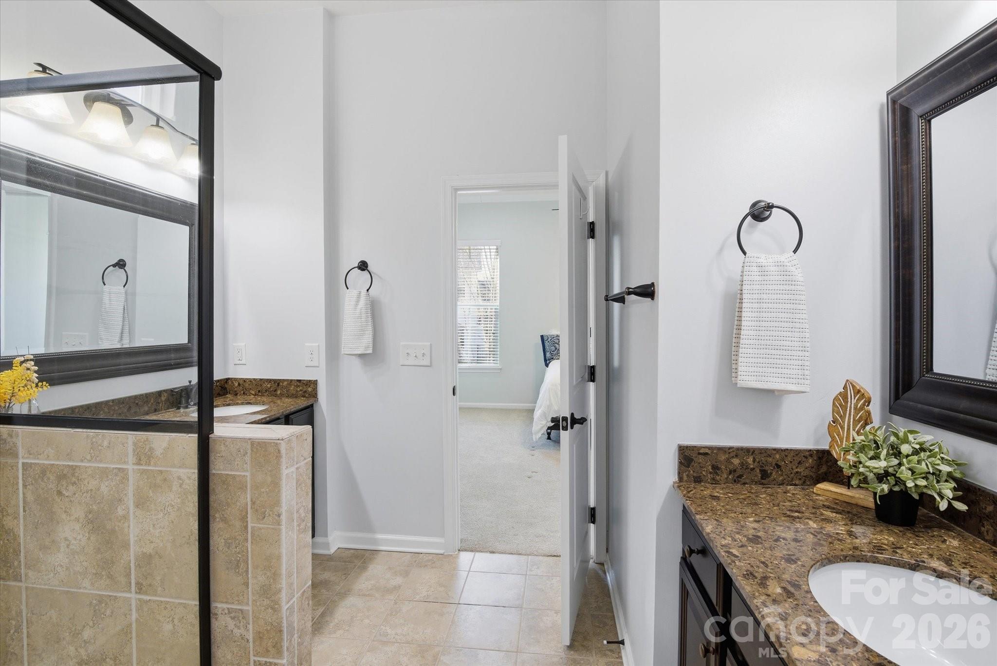 5009 St Clair Street Fort Mill, SC 29715 - Photo 26 of 40 a bathroom with a granite countertop sink and a mirror
