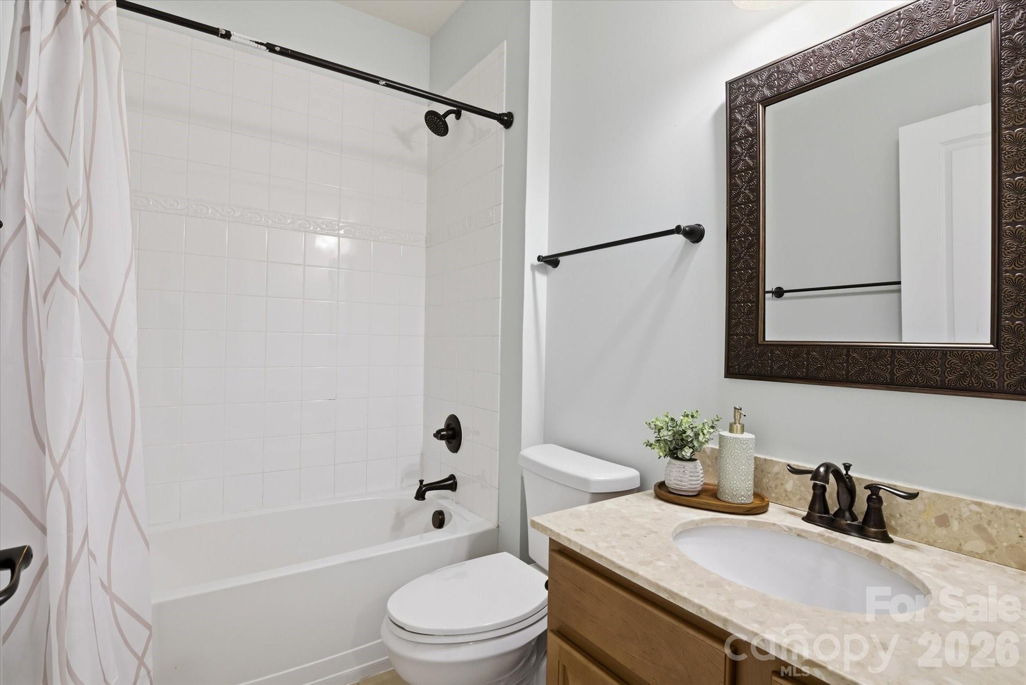 5009 St Clair Street Fort Mill, SC 29715 - Photo 27 of 40 a bathroom with a granite countertop sink toilet and shower