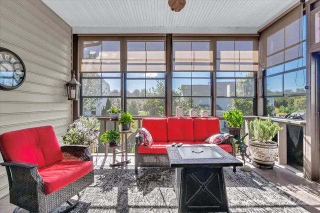 a living room with furniture and a floor to ceiling window