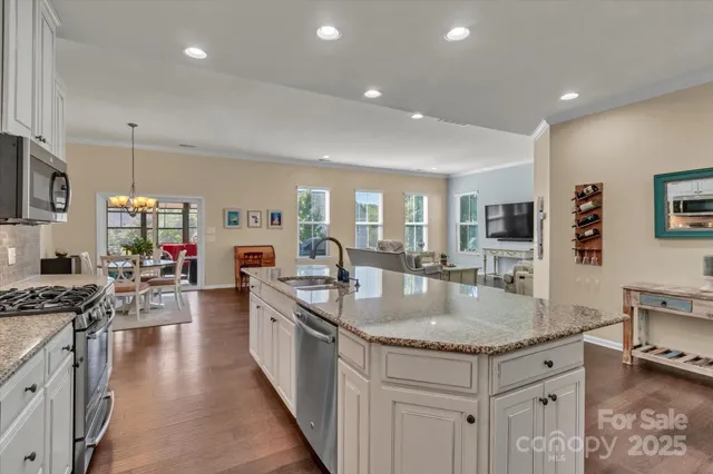 a kitchen with sink stove and refrigerator
