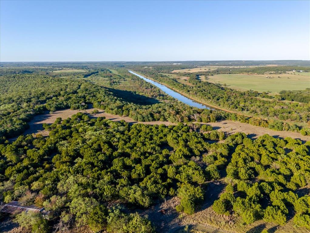 1674 Ming Bend Road Graham, TX 76450 - Photo 29 of 40 Expansive undeveloped land featuring a linear waterway and dense tree coverage