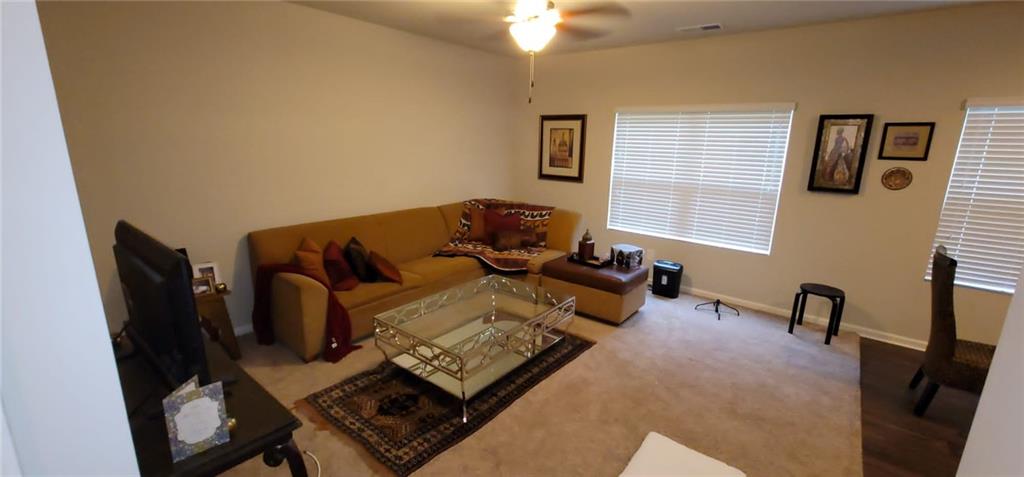 3433 Cascade Parc Boulevard Southwest Atlanta, GA 30311 - Photo 12 of 30 a living room with furniture rug and a window