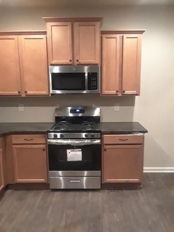 3433 Cascade Parc Boulevard Southwest Atlanta, GA 30311 - Photo 5 of 30 a kitchen with granite countertop a stove and a microwave