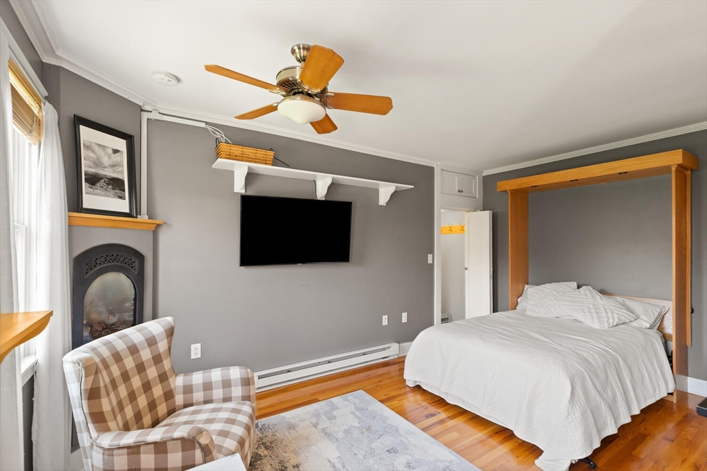 150 Prospect Street, Unit 3 Gloucester, MA 01930 - Photo 13 of 25 a bedroom with a bed and a flat screen tv