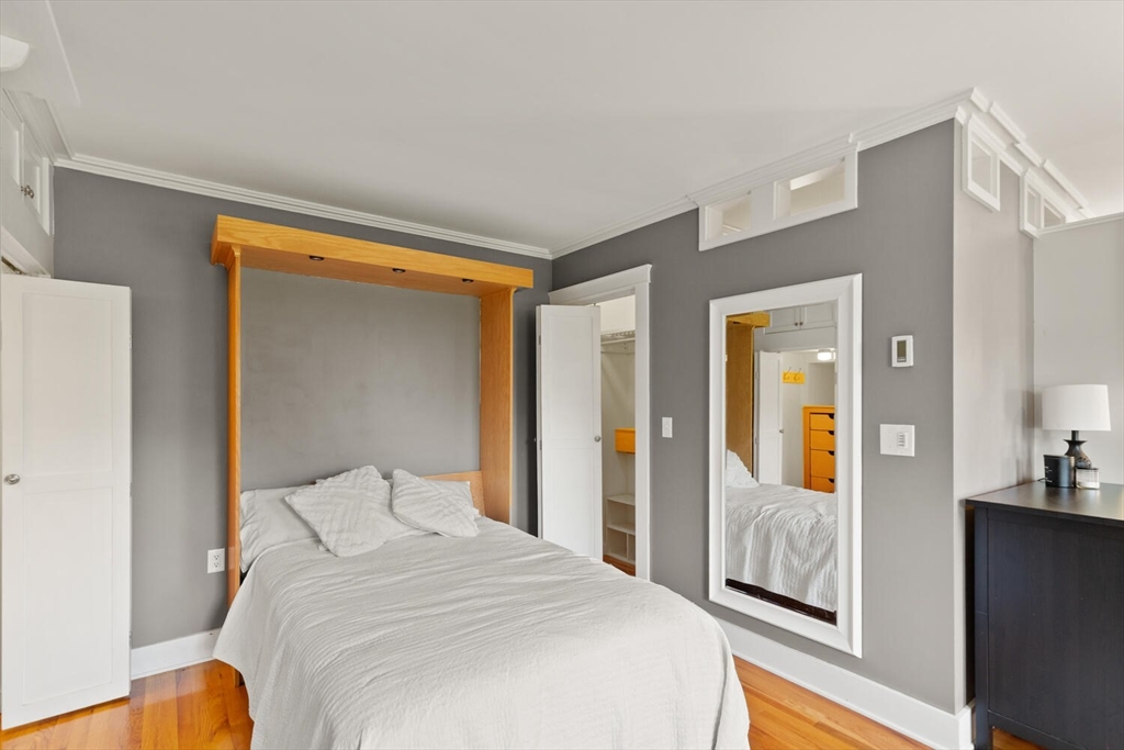 150 Prospect Street, Unit 3 Gloucester, MA 01930 - Photo 14 of 25 a bedroom with a bed and wooden floor