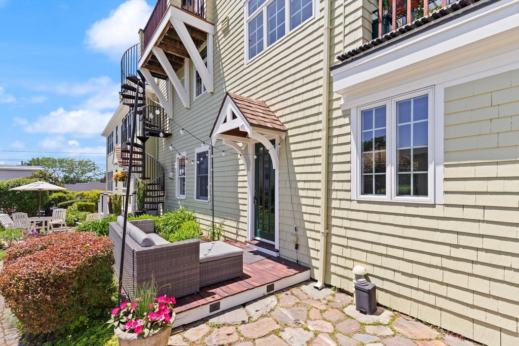 150 Prospect Street, Unit 3 Gloucester, MA 01930 - Photo 19 of 25 a front view of a house with a garden
