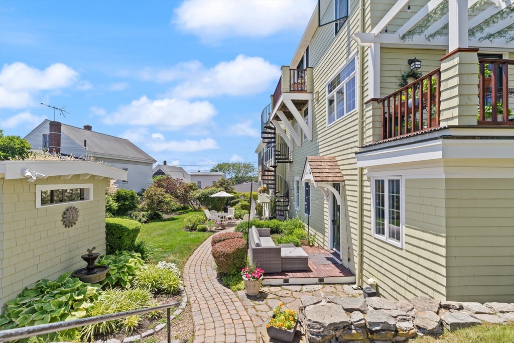 150 Prospect Street, Unit 3 Gloucester, MA 01930 - Photo 20 of 25 a front view of a house with garden
