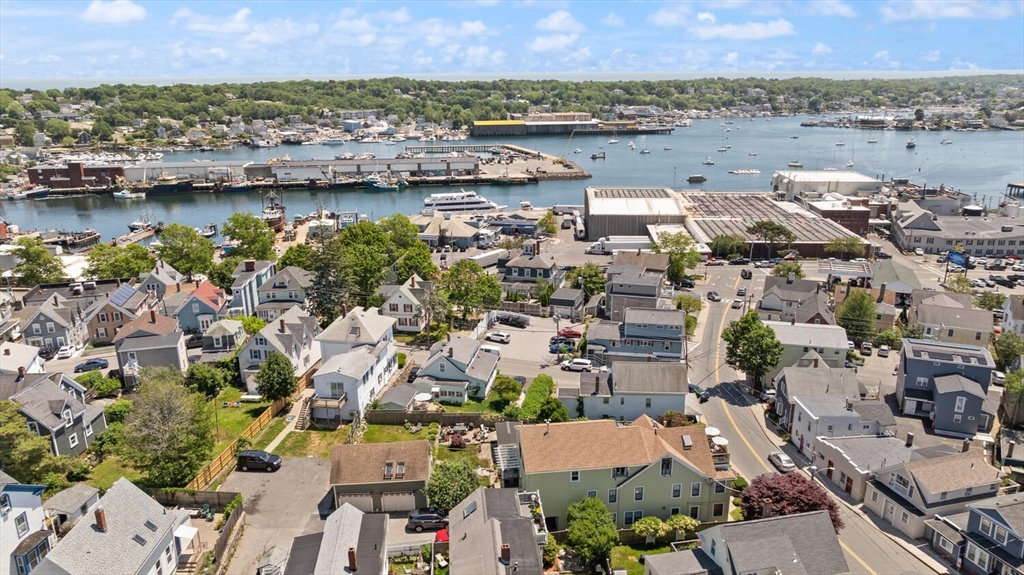 150 Prospect Street, Unit 3 Gloucester, MA 01930 - Photo 22 of 25 an aerial view of ocean and residential houses with outdoor space