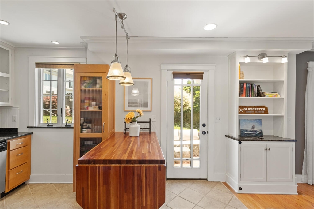 150 Prospect Street, Unit 3 Gloucester, MA 01930 - Photo 8 of 25 a kitchen that has a lot of fruit cabinets and a wooden floor