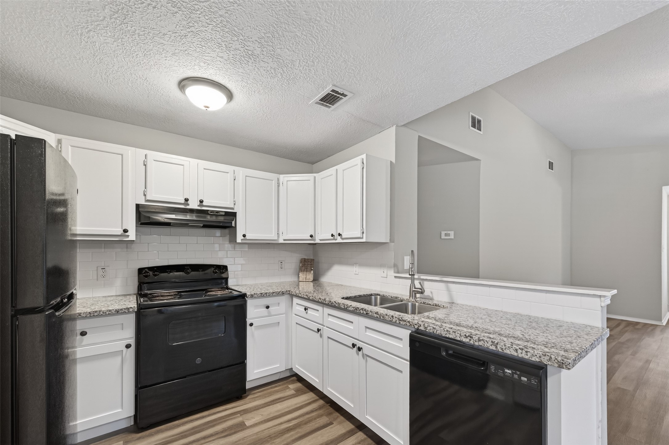 27812 Red Fox Road Tomball, TX 77377 - Photo 12 of 33 a kitchen with stainless steel appliances granite countertop a sink stove and cabinets
