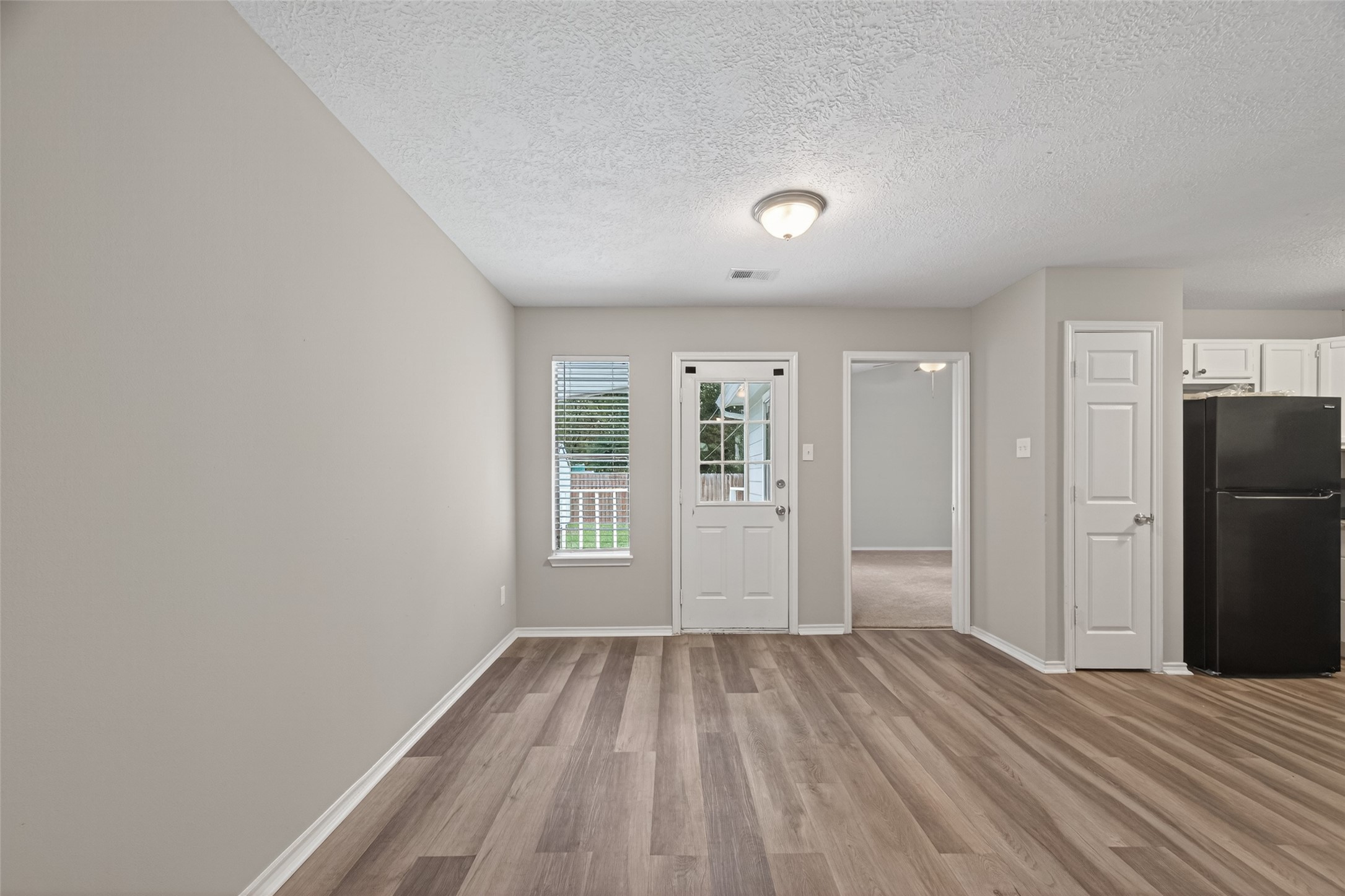 27812 Red Fox Road Tomball, TX 77377 - Photo 3 of 33 wooden floor in an empty room with a window