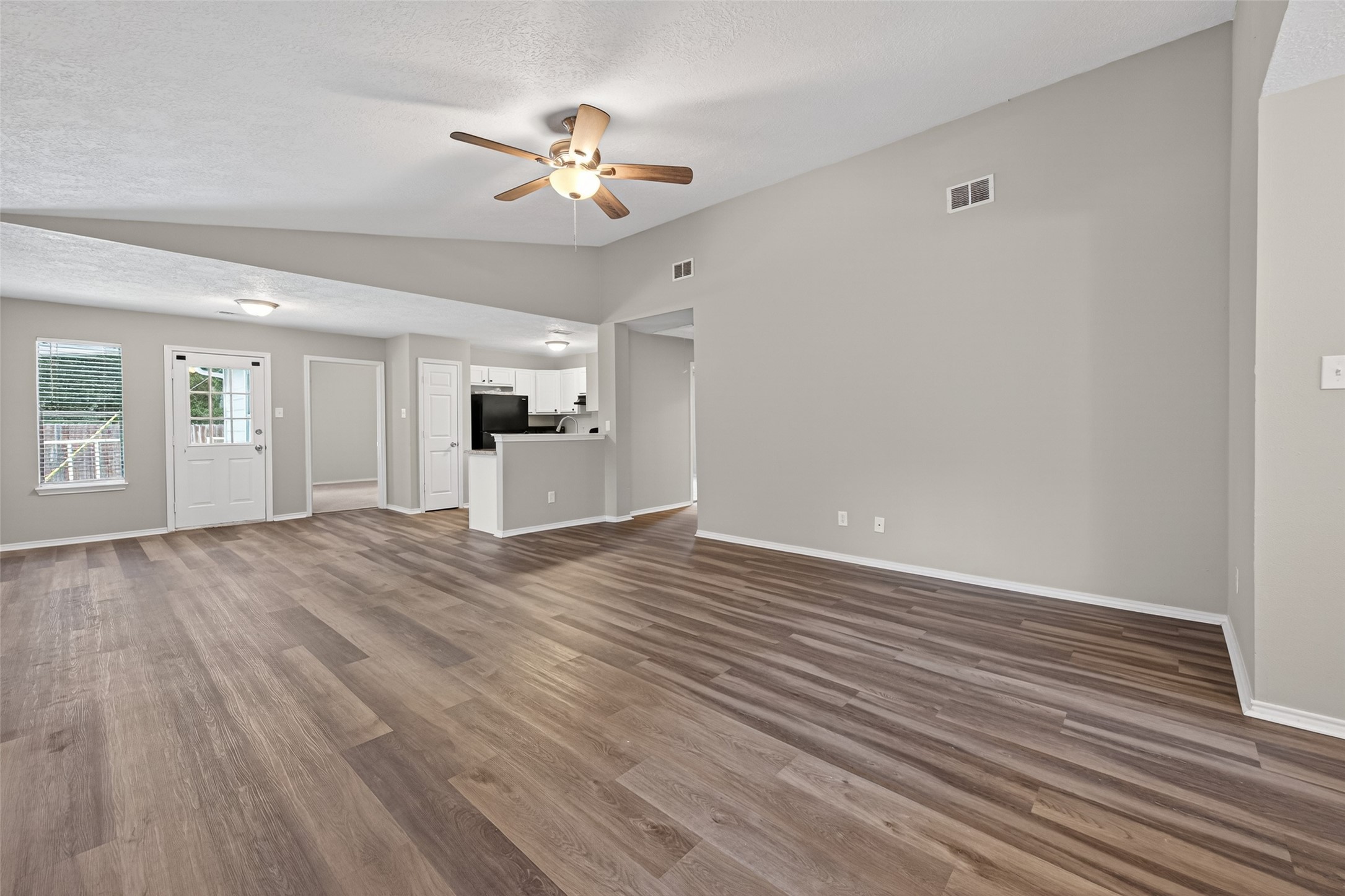 27812 Red Fox Road Tomball, TX 77377 - Photo 4 of 33 a view of an empty room with a window and wooden floor