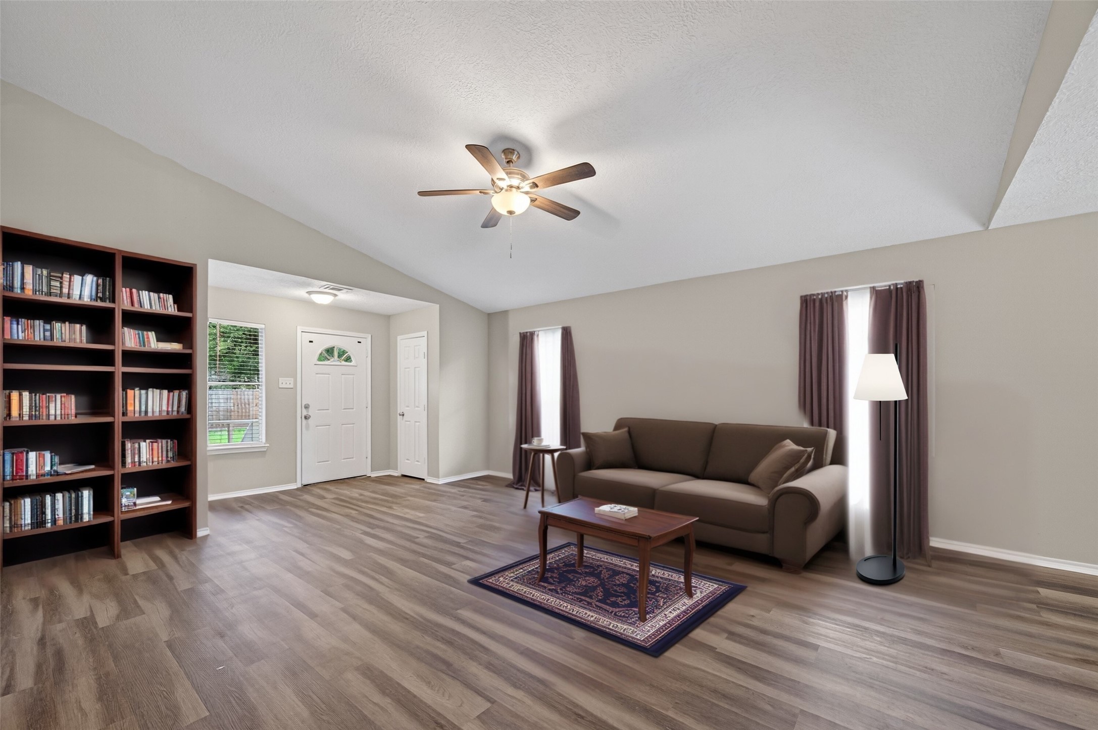 27812 Red Fox Road Tomball, TX 77377 - Photo 7 of 33 a living room with furniture and a book shelf