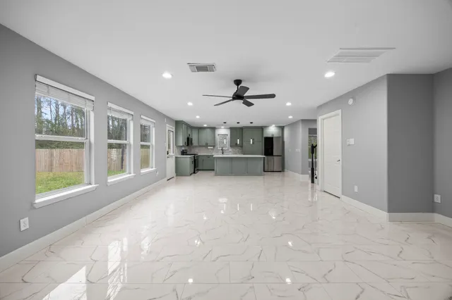 a view of livingroom with hardwood floor and a ceiling fan