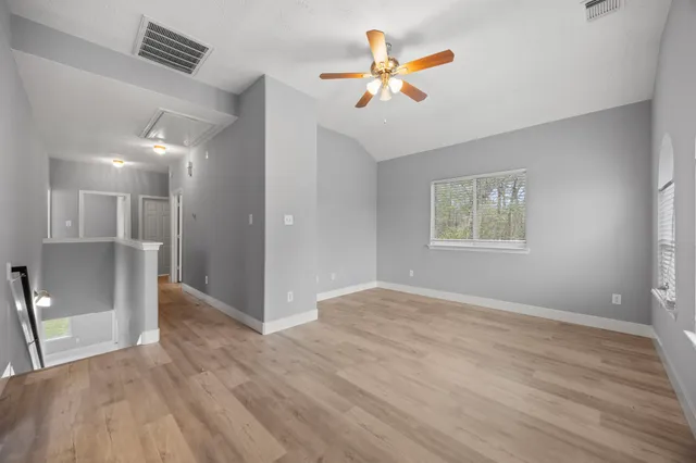 wooden floor in an empty room with a window
