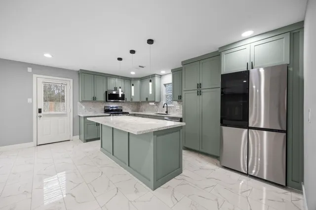 a large kitchen with a sink and cabinets