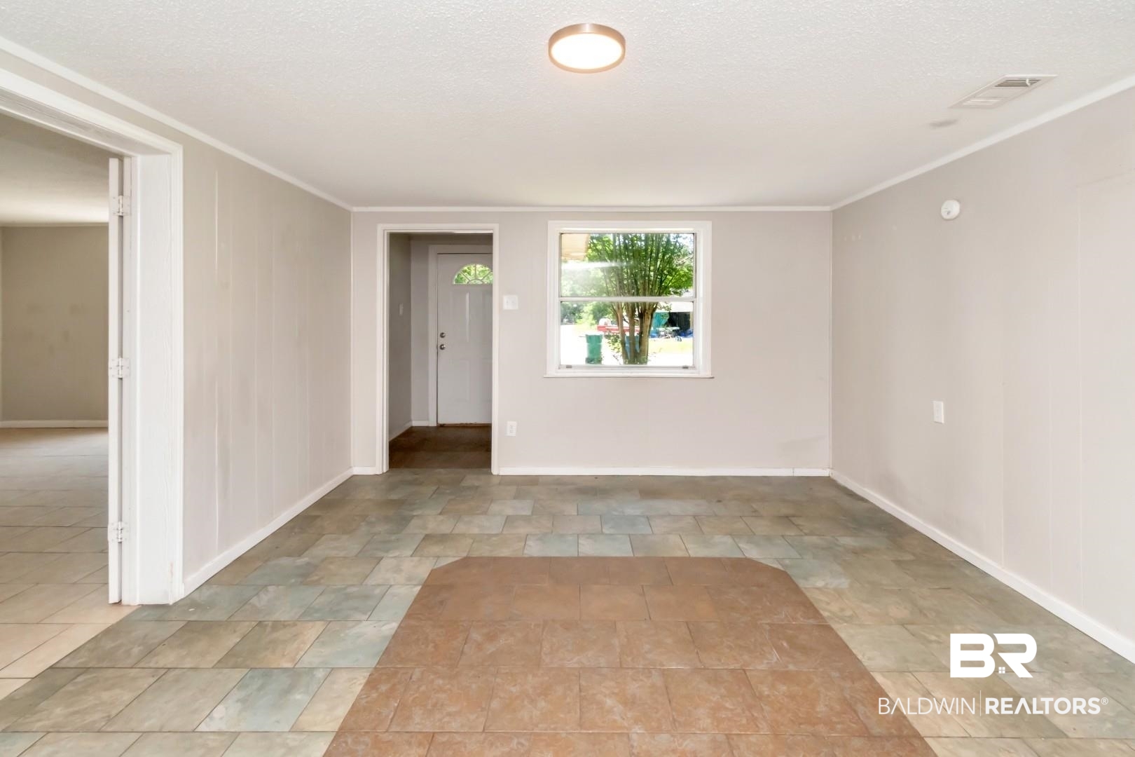 5650 Alice Drive Theodore, AL 36582 - Photo 5 of 15 Empty room with baseboards, ornamental molding, and visible vents