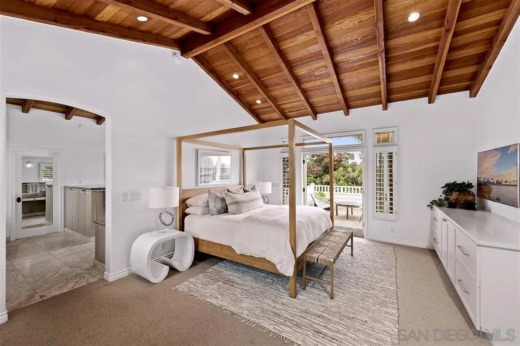 1441 Crest Drive Encinitas, CA 92024 - Photo 11 of 25 a spacious bedroom with a bed couch and a window