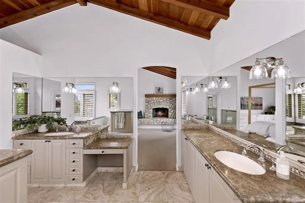 1441 Crest Drive Encinitas, CA 92024 - Photo 12 of 25 a spacious bathroom with a granite countertop sink and a mirror