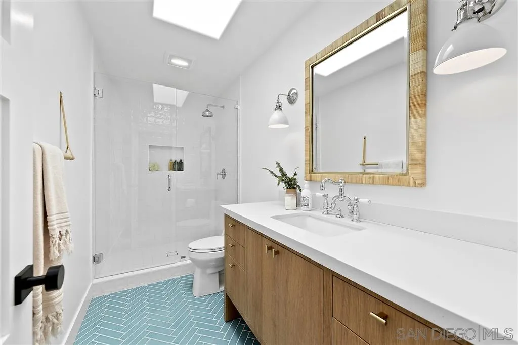 1441 Crest Drive Encinitas, CA 92024 - Photo 17 of 25 a spacious bathroom with a sink a toilet a shower and a mirror