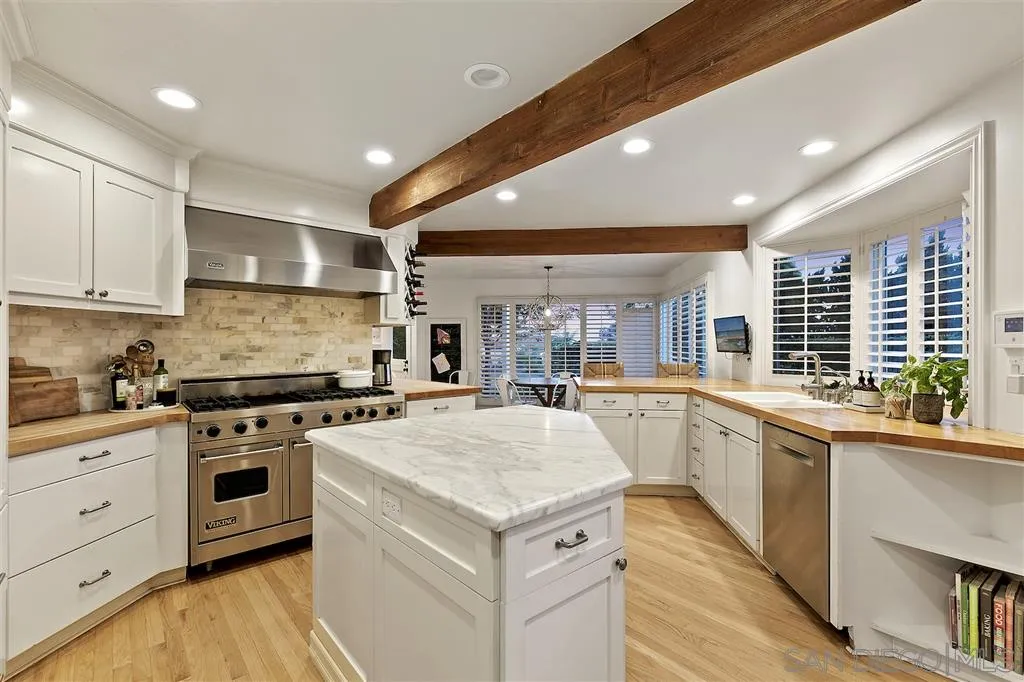 1441 Crest Drive Encinitas, CA 92024 - Photo 5 of 25 a kitchen with a stove sink and cabinets