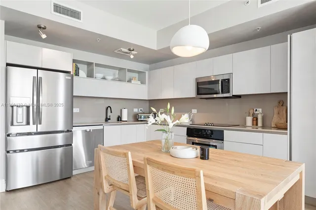 a kitchen with a sink a stove and refrigerator