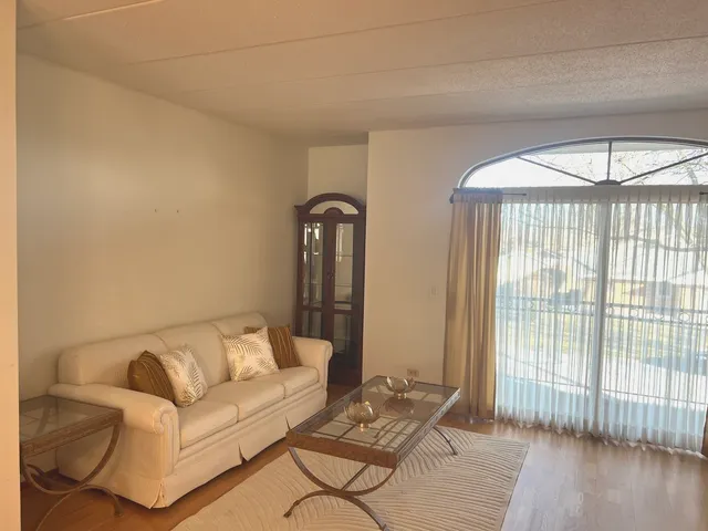 a large bed sitting in a bedroom next to a window