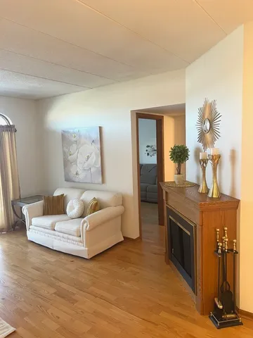 a bedroom with a large bed and wooden floor