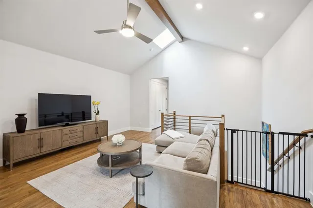 a bedroom with a large bed and a flat screen tv