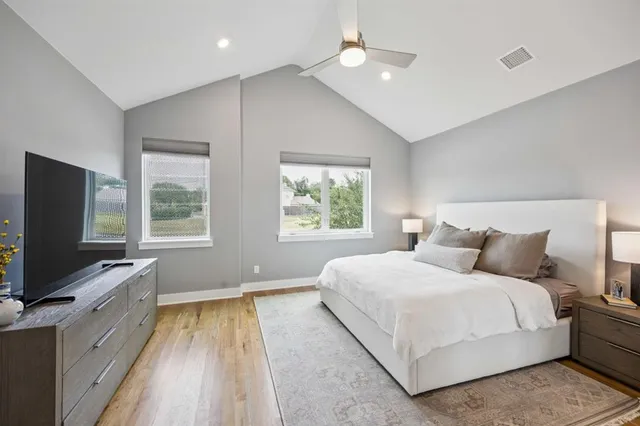 a bedroom with a large bed and a window