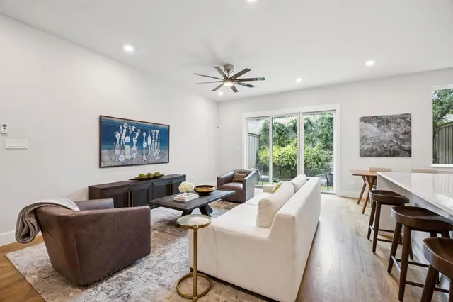 a living room with furniture ceiling fan and a window