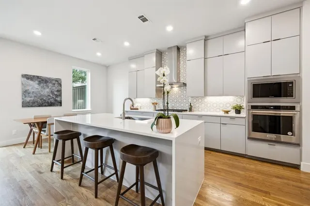 a kitchen with stainless steel appliances kitchen island granite countertop a sink and cabinets