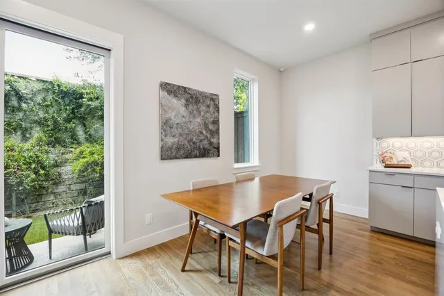 a view of a dining room with furniture window and wooden floor