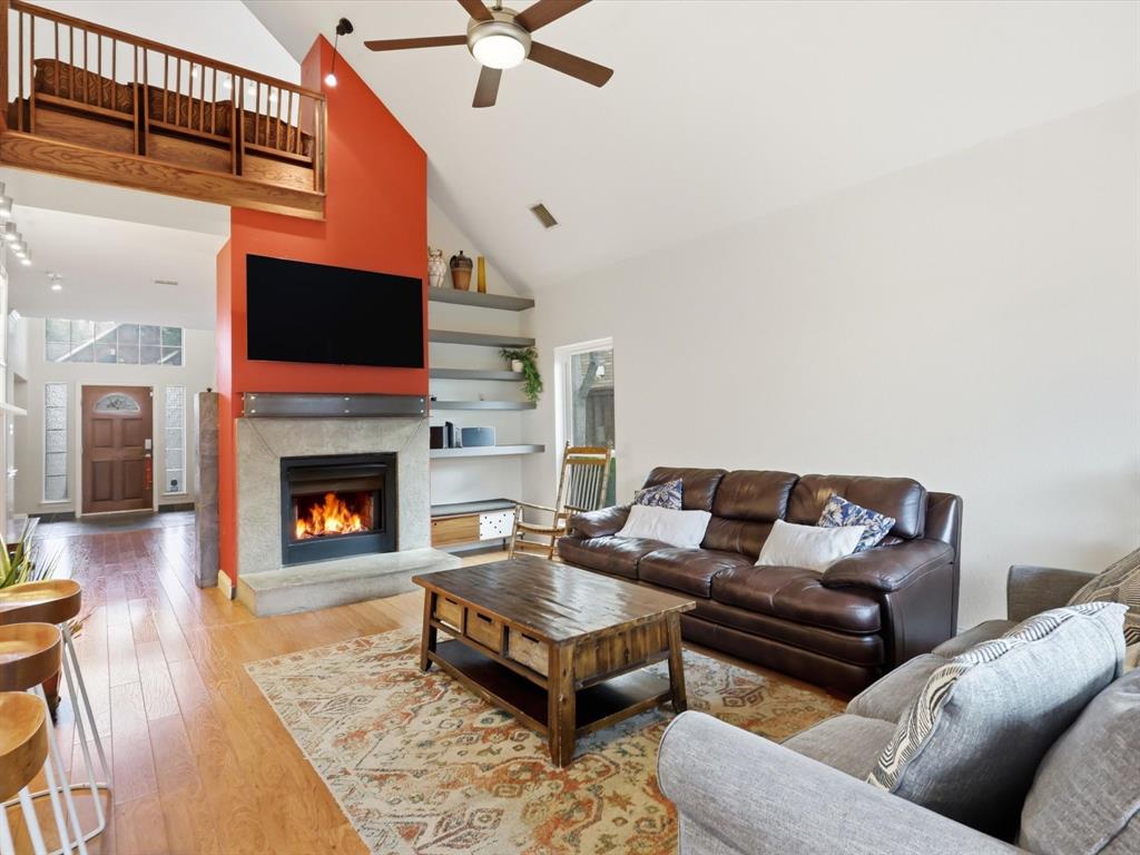 851 Chalfont Place Coppell, TX 75019 - Photo 11 of 36 a living room with furniture a flat screen tv and a fireplace