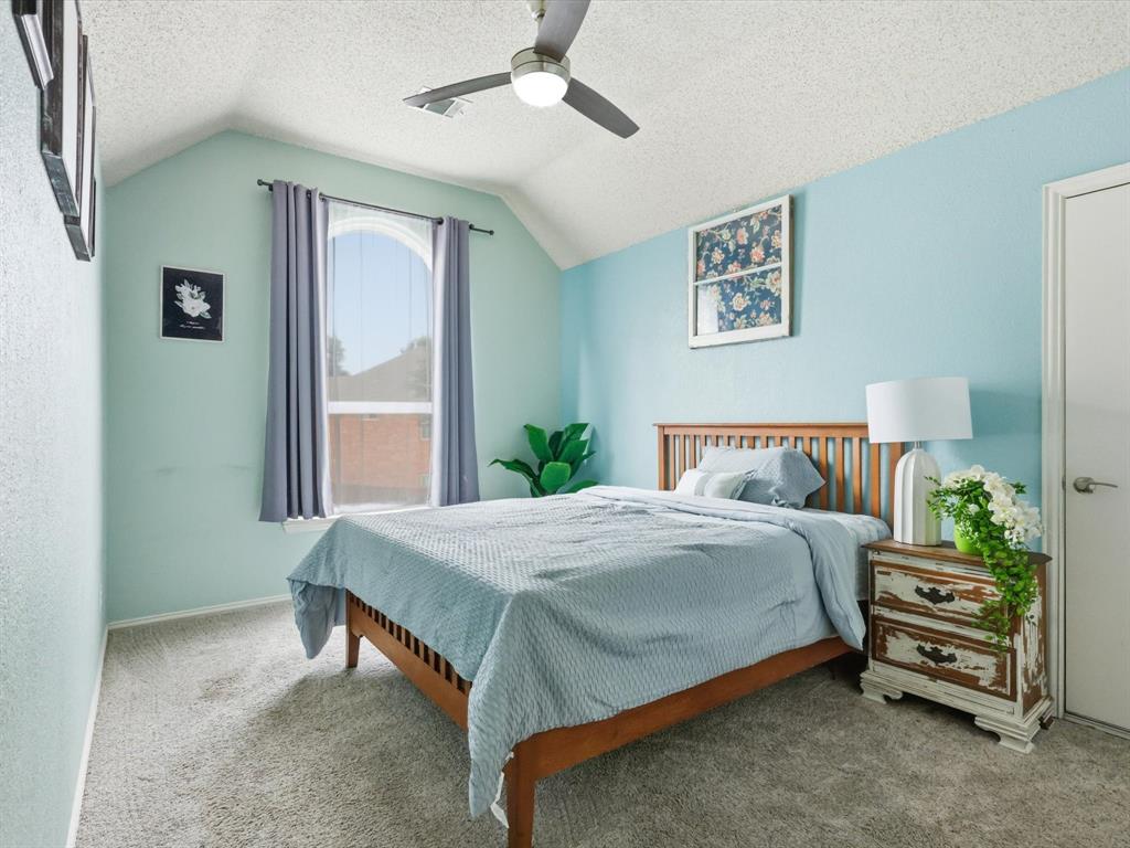851 Chalfont Place Coppell, TX 75019 - Photo 22 of 36 a bedroom with a bed a couch and a window
