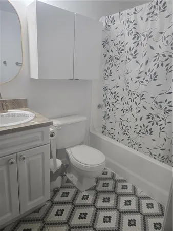 a bathroom with a toilet and a shower curtain